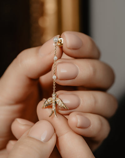 A perfect love token piece of jewelry! Romantic and very symbolic these antique revival drop earrings are handmade by our goldsmiths. Made of solid 10k yellow gold, these beautiful Victorian style swallow earrings are set with natural pearls.