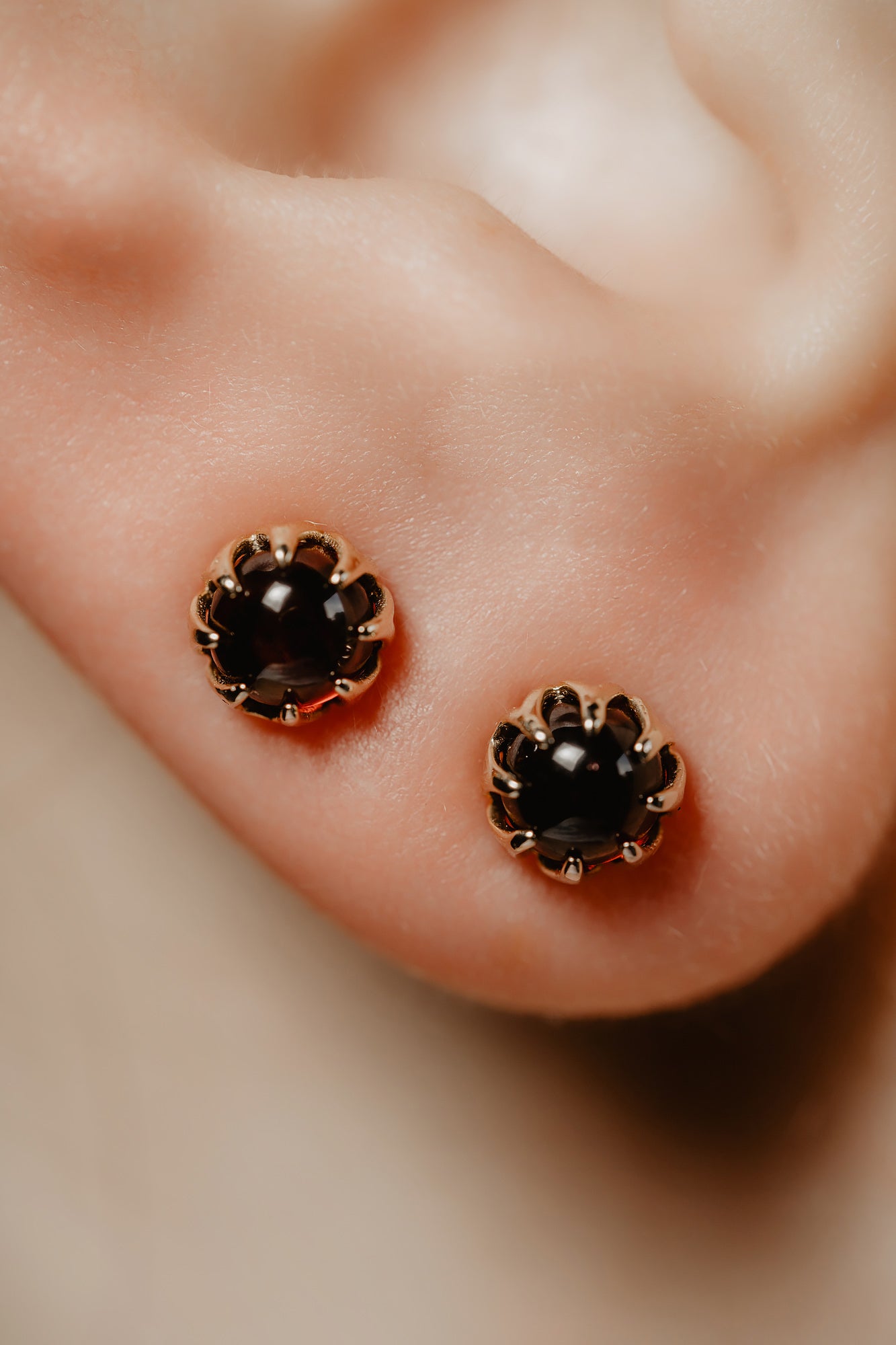 Mystic shimmer of deep-red garnet - these antique revival garnet cabochon studs are designed by our goldsmiths. Made of solid 10k yellow gold, these gold oriental style earrings are inspired by Ottoman architecture.