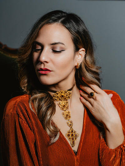 Unisex solid gold ring set with a garnet cabochon. A stunning revival of the 19th century jewelry designs and heavily inspired by oriental influence.  This ring is skuilfully hand-crafted by our goldsmith from recycled gold and ethically sourced garnet.