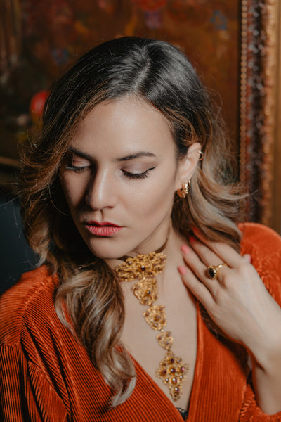 Unisex solid gold ring set with a garnet cabochon. A stunning revival of the 19th century jewelry designs and heavily inspired by oriental influence.  This ring is skuilfully hand-crafted by our goldsmith from recycled gold and ethically sourced garnet.