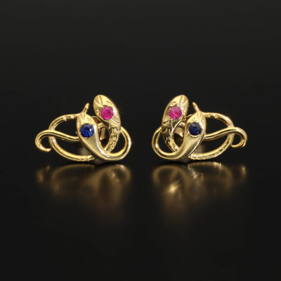 Victorian revival double headed snake studs. Made of solid rose or yellow gold with natural rubies and sapphires. Unique artisan stud earrings. Handmade of solid gold. Perfect gift idea for her! Journey Jewellery online design jewelry shop.