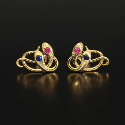 Victorian revival double headed snake studs. Made of solid rose or yellow gold with natural rubies and sapphires. Unique artisan stud earrings. Handmade of solid gold. Perfect gift idea for her! Journey Jewellery online design jewelry shop.