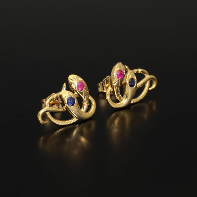 Victorian revival double headed snake studs. Made of solid rose or yellow gold with natural rubies and sapphires. Unique artisan stud earrings. Handmade of solid gold. Perfect gift idea for her! Journey Jewellery online design jewelry shop.