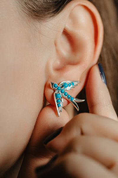 A perfect love token piece of jewelry! Romantic and very symbolic this antique revival stud is handmade by our goldsmiths. Made of solid sterling silver, this beautiful Victorian style swallow earring is set with natural turquoise cabochons. The earrings have an omega lock for a secure placement.   The design of this earrings is a replica of a swallow motive which was widely popular in Victorian era. The symbolism behind swallow jewellery is utterly romantic.