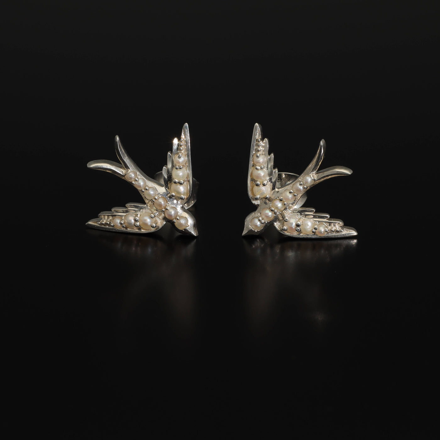 A perfect love token piece of jewelry! Romantic and very symbolic these antique revival studs are handmade by our goldsmiths. Made of solid 14k yellow gold or sterling silver, these beautiful antique style swallow earrings are set with natural pearls.