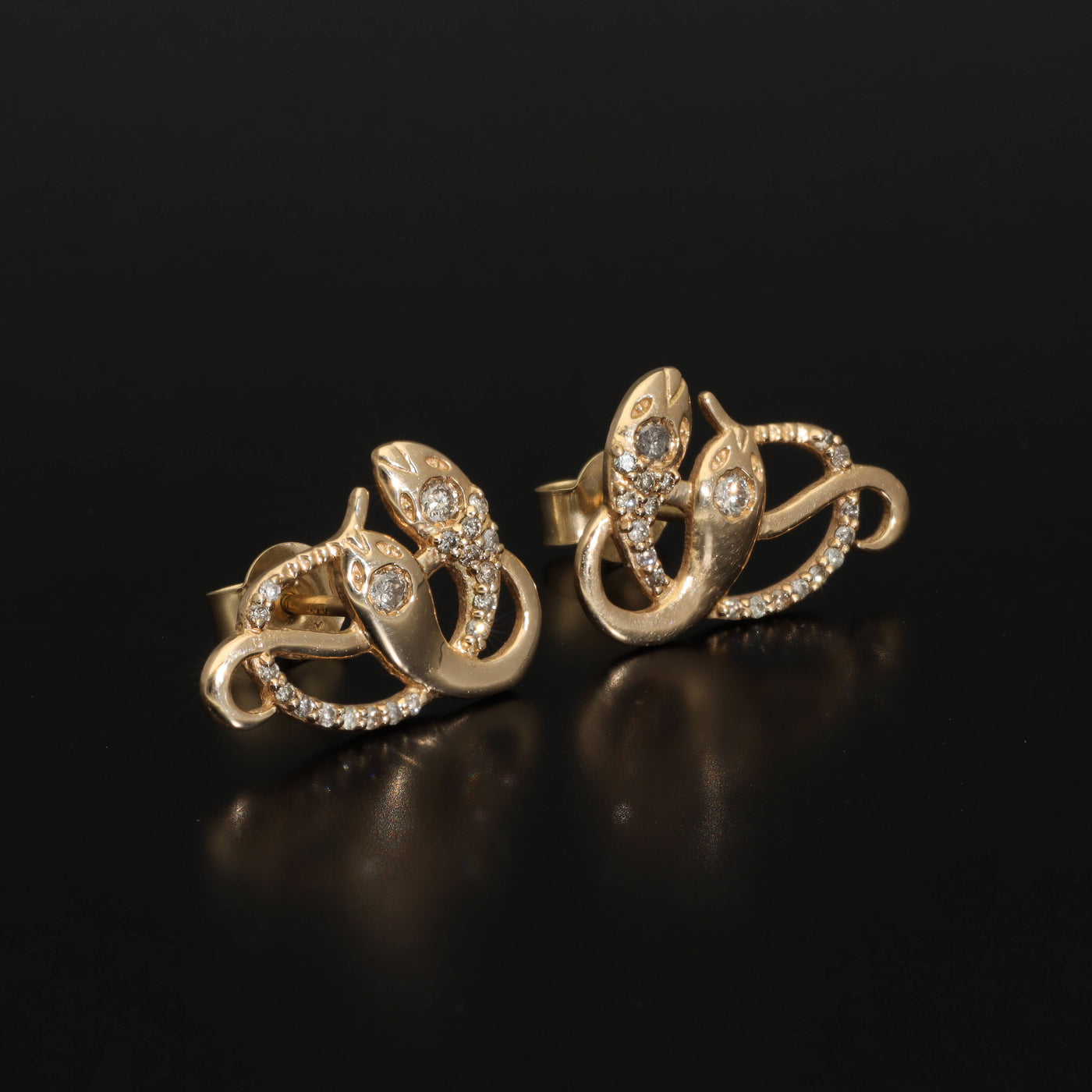 Inspired by the 19th century animal jewelry, these artisan solid gold snake studs are set with the natural mined diamonds.  Handmade with love and passion, these statement unisex earrings are made of solid 14 carat yellow gold and are set with 46 sparkling diamonds.  Here they come, your unorthodox diamond studs!