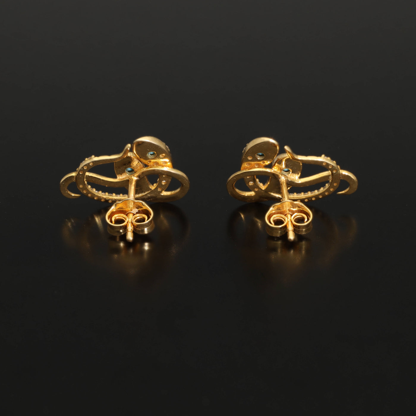 Inspired by the 19th century animal jewelry, these artisan solid gold snake studs are set with the natural precious stones.  Handmade with care, these statement unisex earrings are made of solid 14 carat yellow gold and are set with mined natural diamonds and turquoise.