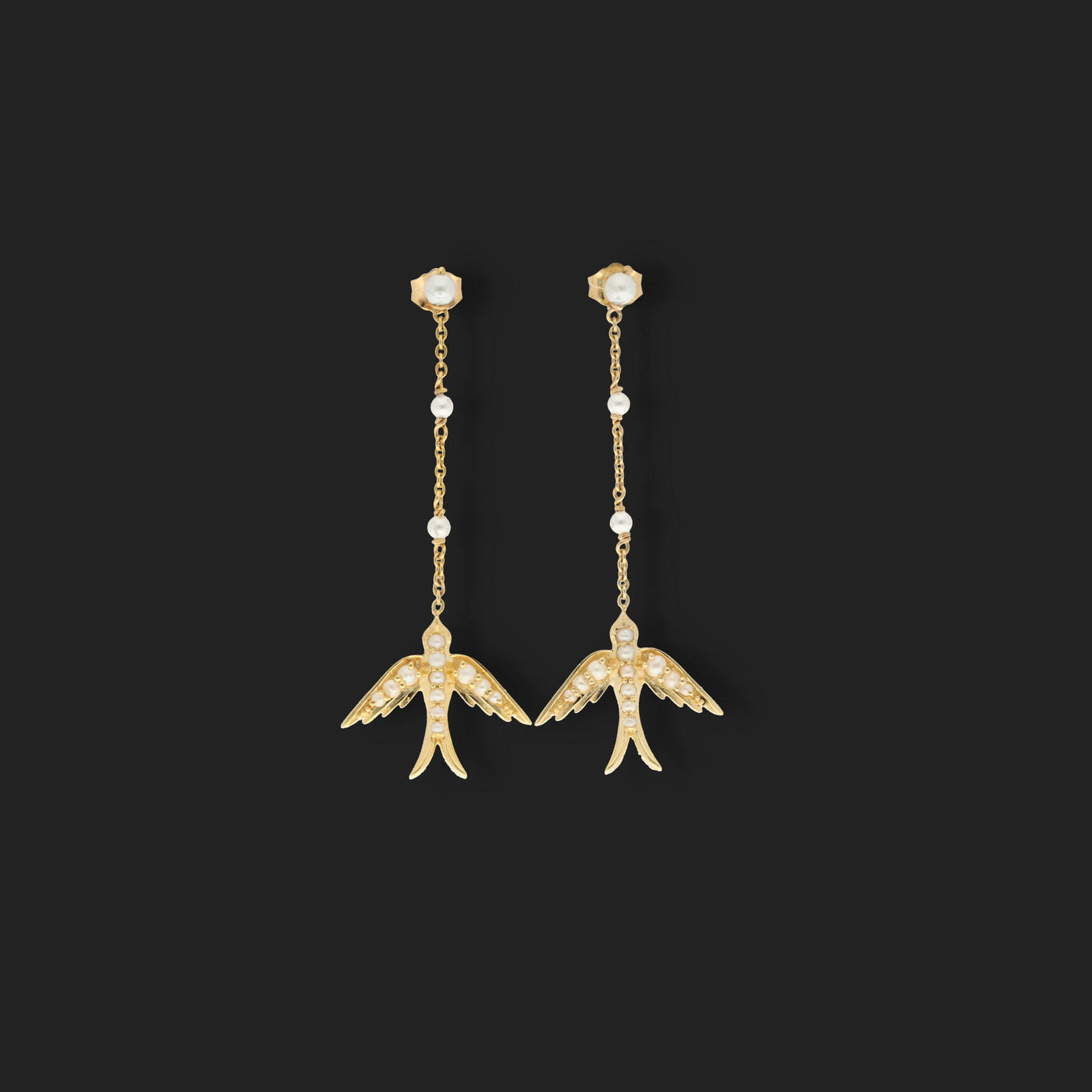 A perfect love token piece of jewelry! Romantic and very symbolic these antique revival drop earrings are handmade by our goldsmiths. Made of solid 10k yellow gold, these beautiful Victorian style swallow earrings are set with natural pearls.