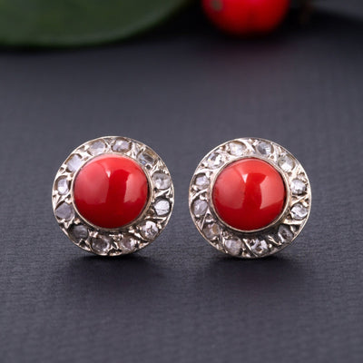 A statement pair of vintage mid-century earrings made of solid 18 kt gold. These head-turning earrings have a classic geometric design and are set with two large red coral cabochons.  The coral cabochons measure 0.35 inch in diameter each and are in a lovely vintage condition with no surface wear.