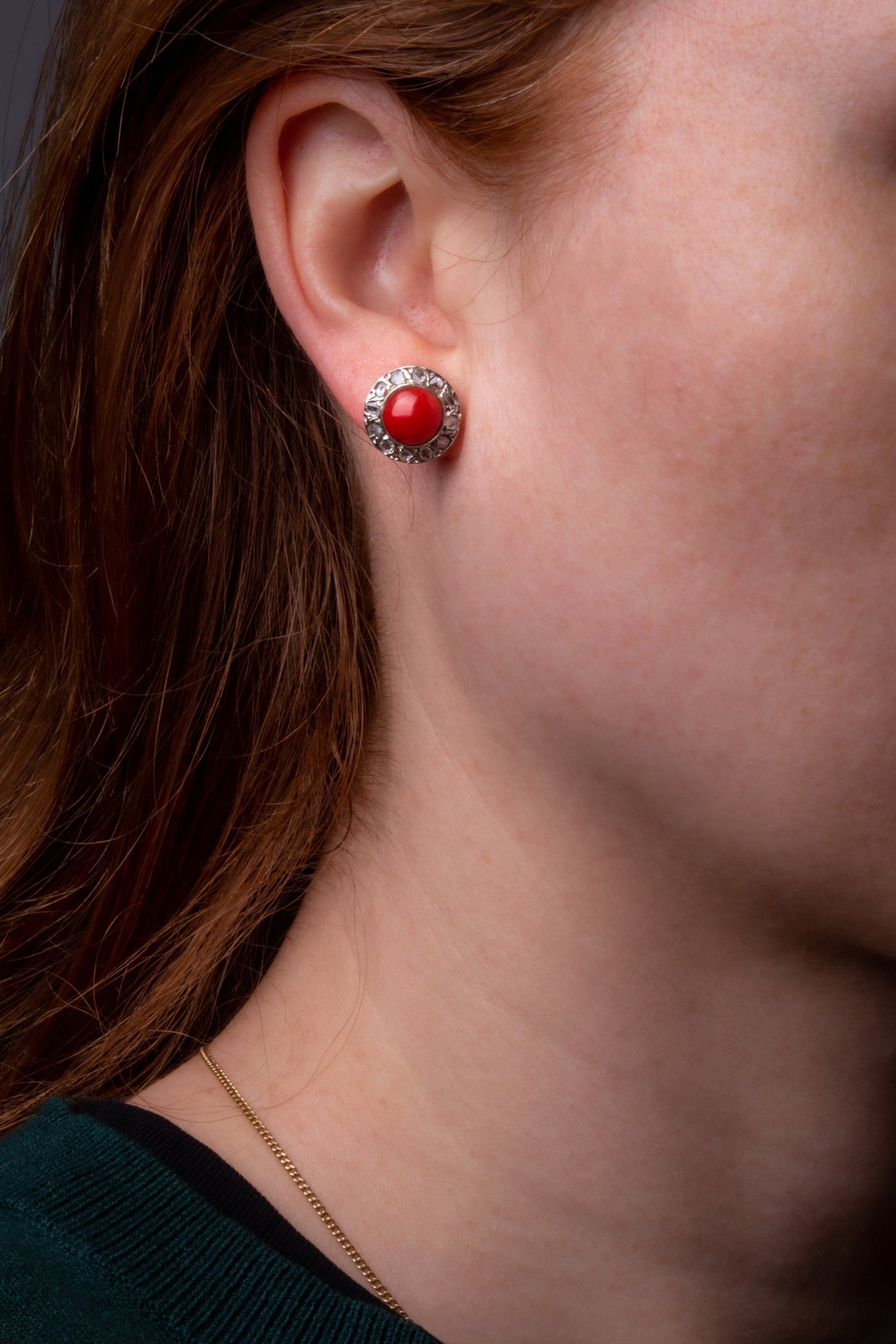 A statement pair of vintage mid-century earrings made of solid 18 kt gold. These head-turning earrings have a classic geometric design and are set with two large red coral cabochons.  The coral cabochons measure 0.35 inch in diameter each and are in a lovely vintage condition with no surface wear.