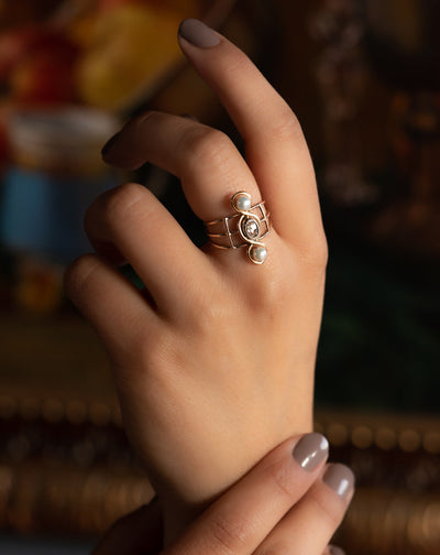 A very unusual Victorian revival three-stones ring, featuring two snow-white pearls and a chunky oval rose cut diamond of circa 0.8 ct.